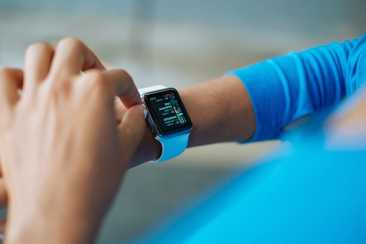 person operating smartwatch